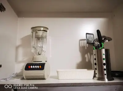 a kitchen counter with a blender and utensils at Hotel style Unit 2924 Fame in Manila