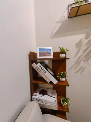 a room with a book shelf with books at 1BR Condotel with Balcony at FAME Residences #FM51 in Manila
