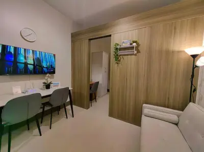 a dining room with a table and chairs in a room at 1BR Condotel with Balcony at FAME Residences #FM52 in Manila