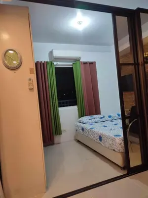 a small room with a bed and a window at Jinh's place to STAYCATION in Manila