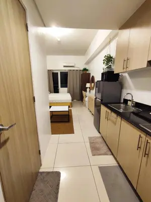 a small kitchen with a sink and a room at Jinh's place to STAYCATION in Manila