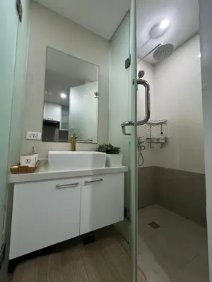 a bathroom with a white sink and a mirror at Mi Casa - Cozy Studio with FREE access to Fitness Centre, swimming pool and stunning City View located near the CBD of Ortigas, Makati, BGC in Manila