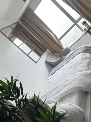 a bedroom with a bed and a skylight at Mi Casa - Cozy Studio with FREE access to Fitness Centre, swimming pool and stunning City View located near the CBD of Ortigas, Makati, BGC in Manila