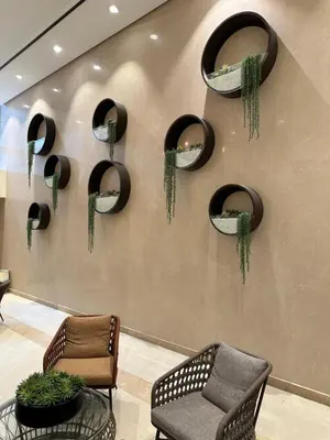 a lobby with chairs and mirrors on a wall at Park Mckinley West 1BR in Manila