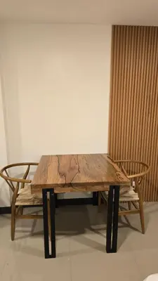 a wooden table with two chairs and a bench at Flat 35, Unit 1B in Manila