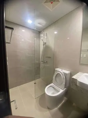 a bathroom with a shower and a toilet and a sink at Park McKinley West unit 9Y Tower B in Manila