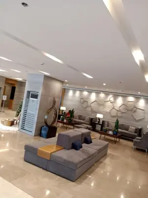 a large living room with a couch and tables at The Manor at S Residences in Manila