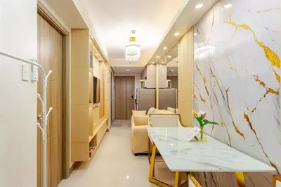 a corridor of a hospital room with a table and chairs at The Manor at S Residences in Manila