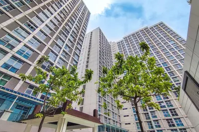 a view of tall buildings in a city with trees at Japanese Stylish Condo in Makati in Manila