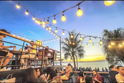a group of people sitting at a bar with lights at Near MOA Manila Bay Airport via NAIAX Balcony-Pool View WiFi SHELL Residences in Manila