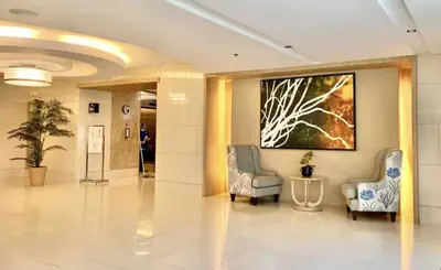 a lobby with two chairs and a painting on the wall at Near MOA Manila Bay Airport via NAIAX Balcony-Pool View WiFi SHELL Residences in Manila