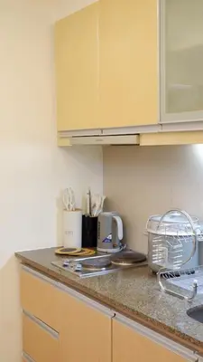 a kitchen with a counter top with a counter top at New Cozy Condo in Eastwood in Manila
