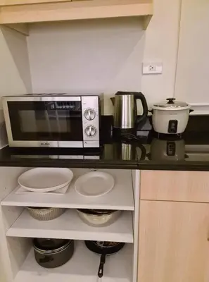 a kitchen counter with a microwave and a coffee maker at 3BR Elegant & Central Loc- Netflix, WiFi, MiniBar! in Manila
