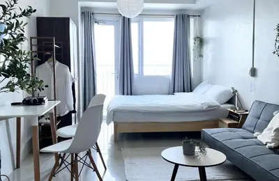 a small bedroom with a bed and a couch at Vibrant Makati Studio in Manila