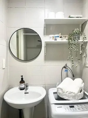 a bathroom with a sink and a mirror at Vibrant Makati Studio in Manila