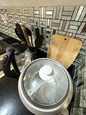 a kitchen counter top with a pot on a counter top at Gray Room Shore 2 Residences in Manila