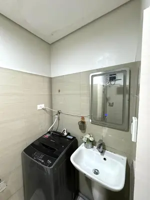 a bathroom with a sink and a mirror at Gray Room Shore 2 Residences in Manila