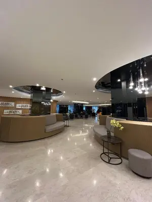 a lobby with couches and tables in a building at Shore 2 Residences Tuscia Home Staycation in Manila