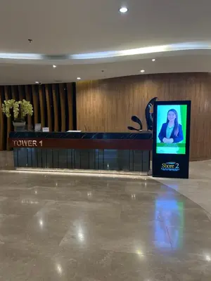 a lobby with a tv screen in a building at Shore 2 Residences Tuscia Home Staycation in Manila