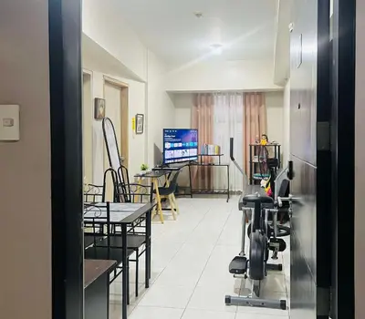 a room with a gym with chairs and a table at 2 Bedroom condo unit in Manila