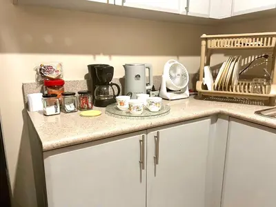 a kitchen counter with cups and appliances on it at 2 Bedroom condo unit in Manila