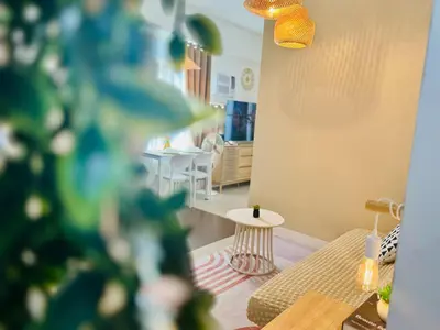 a living room with a couch and a table at Budget Friendly Staycation walking distance to Venice Mall with Netflix and Wifi in Manila