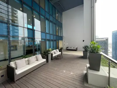 a balcony of a building with couches and plants at Cozy place across Mitsukoshi Mall in Manila