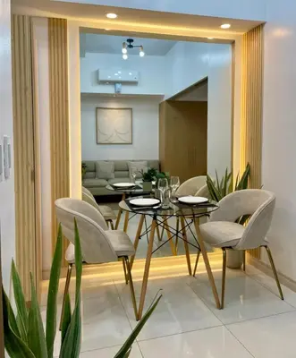a dining room with a table and chairs at Cozy place across Mitsukoshi Mall in Manila