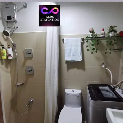 a bathroom with a shower and a toilet and a sink at Shore 3 tower 2 mall of Asia in Manila