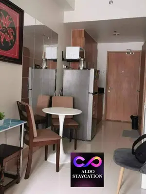 a kitchen with a table and chairs and a refrigerator at Shore 3 tower 2 mall of Asia in Manila