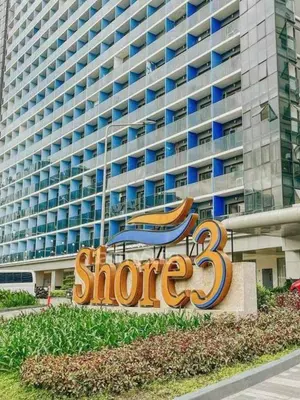 a sign in front of a large building at Shore 3 tower 2 mall of Asia in Manila