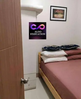 a bedroom with a bed and a sign on the wall at Shore 3 tower 2 mall of Asia in Manila