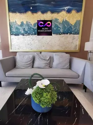 a living room with a couch and a coffee table at Shore 3 tower 2 mall of Asia in Manila