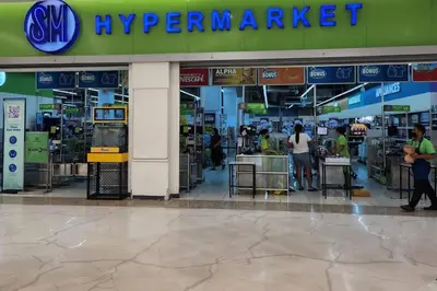 a supermarket with people sitting at tables in a store at Cozy Makati Condo Getaway with balcony in Manila