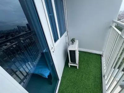 a balcony with a table and a chair on a building at Cozy Makati Condo Getaway with balcony in Manila