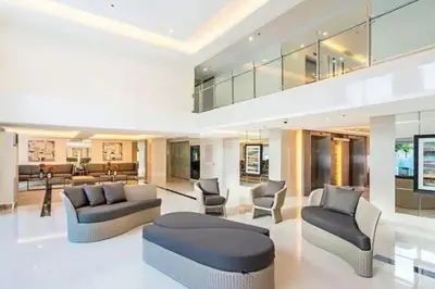 a large living room with two couches and chairs at Cozy Makati Condo Getaway with balcony in Manila