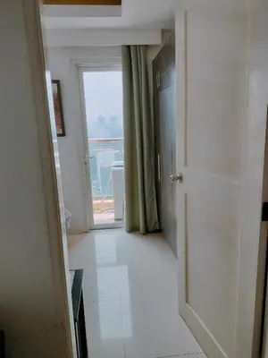 an empty hallway with a door and a window at Explore Manila, Trendy 1BR unit in Prime Location in Manila