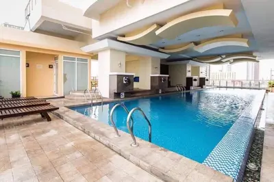 a large swimming pool in a hotel room at Explore Manila, Trendy 1BR unit in Prime Location in Manila