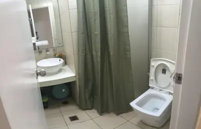 a bathroom with a sink and a toilet and a shower at Explore Manila, Trendy 1BR unit in Prime Location in Manila