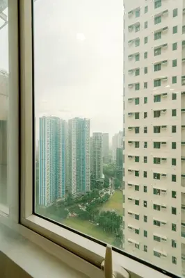 a window view of a city with tall buildings at Cozy and Spacious Studio at SOMA BGC Near SM Aura and Bonifacio High Street in Manila