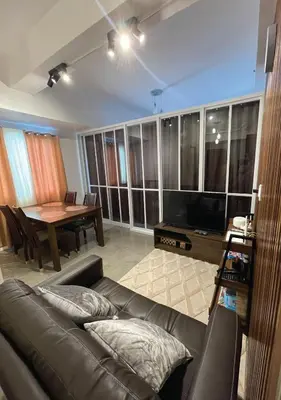 a living room with a couch and a table at The Cozy Corner in Manila