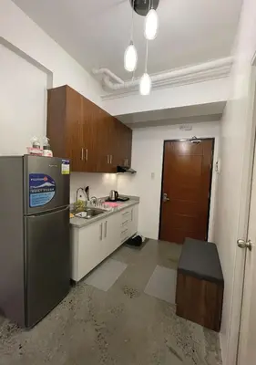 an empty kitchen with a refrigerator and a sink at The Cozy Corner in Manila