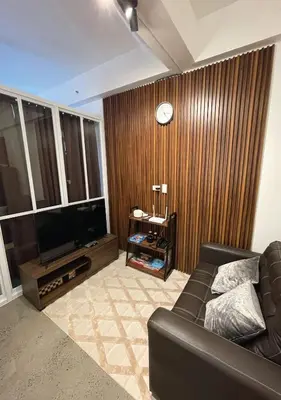 a living room with a couch and a television at The Cozy Corner in Manila
