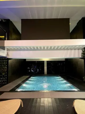 a large swimming pool in a building at Spacious Unit in Gramercy Makati in Manila