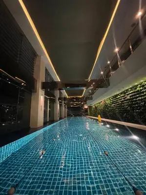 a swimming pool with turtles in a building at Spacious Unit in Gramercy Makati in Manila