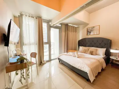 a bedroom with a large bed and a large window at Luxury BGC Condo Near Uptown,Grand Hyatt #upt219k in Manila