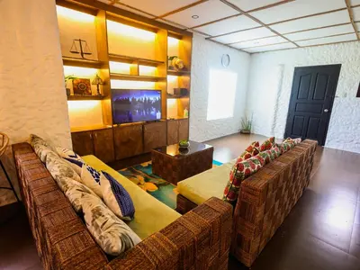 a living room with two couches and a tv at Kasa Silang by Araw Residences in Cavite