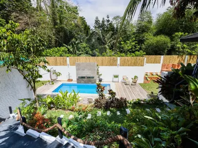 a garden with a swimming pool in a yard at Kasa Silang by Araw Residences in Cavite