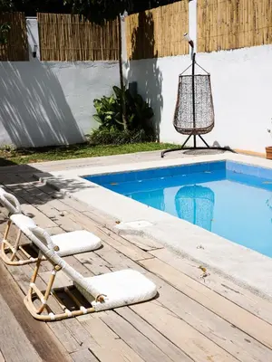 a lounge chair sitting next to a swimming pool at Kasa Silang by Araw Residences in Cavite