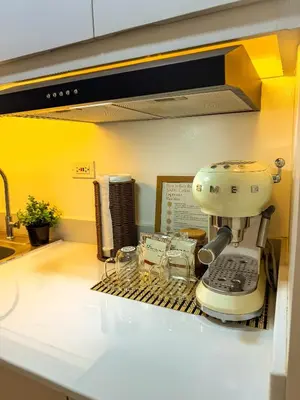 a kitchen counter with a mixer on a drying rack at Natural Haven at South in Manila